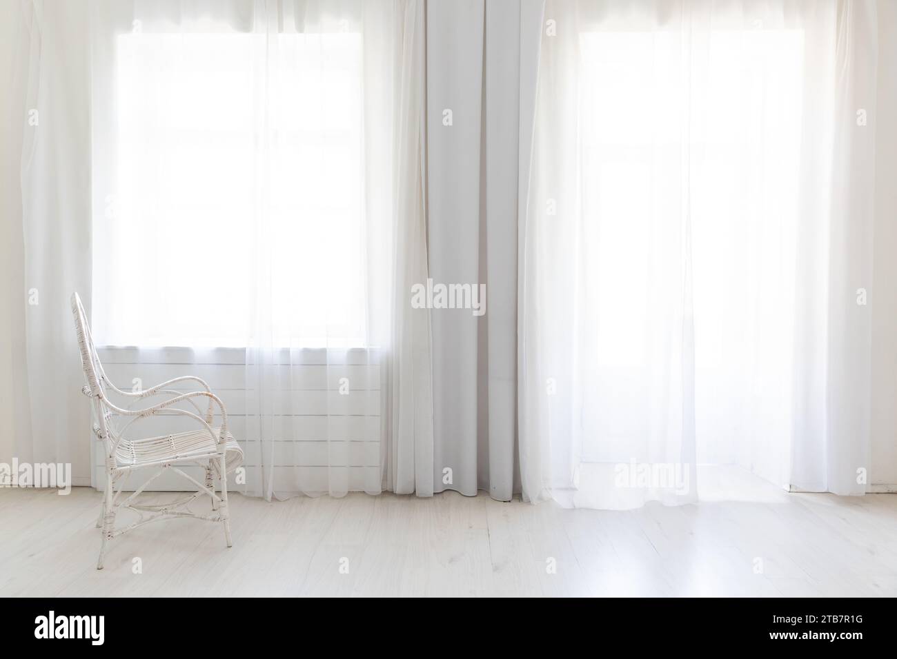 Vintage armchair in white room interior with windows Stock Photo - Alamy