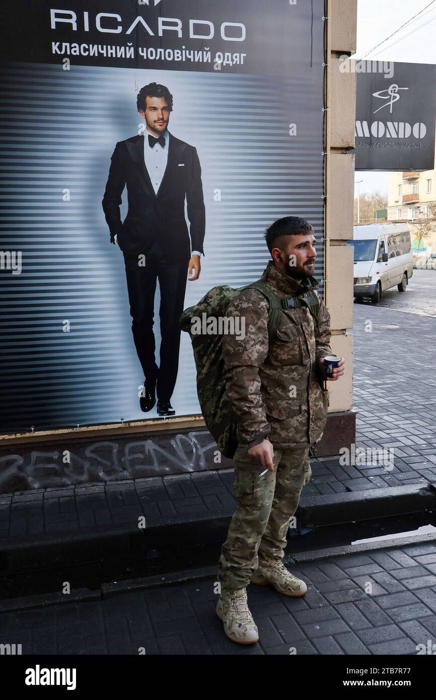 A Ukrainian army soldier is seen during a coffee break while waiting
