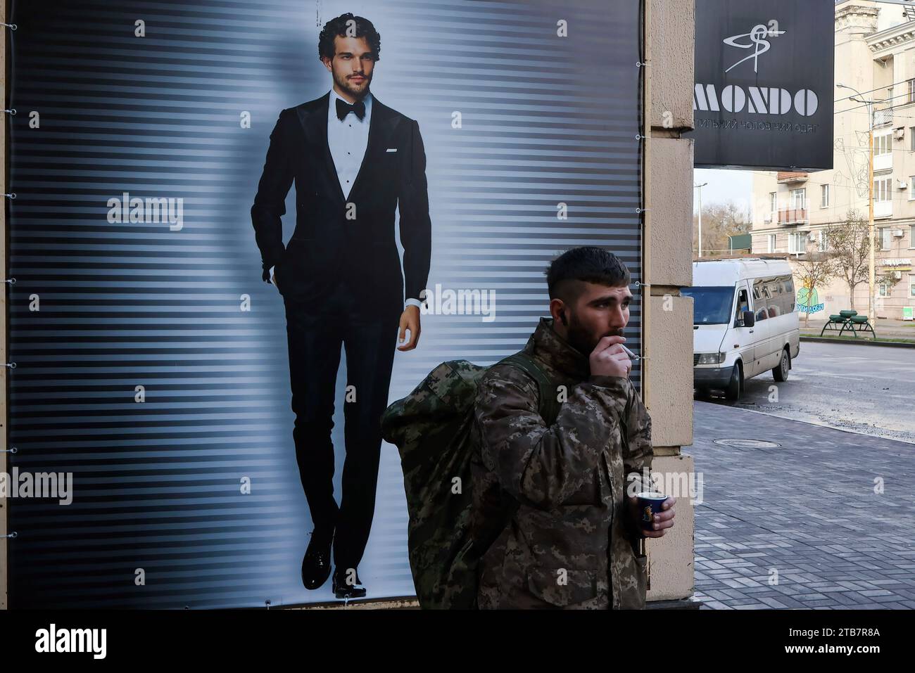 A Ukrainian army soldier is seen during a coffee break while waiting