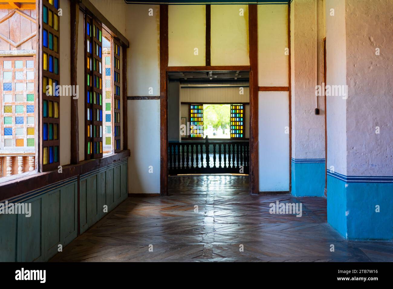 A Lazi Convent featuring multiple glass windows and light brown flooring in Siquijor, Philippines Stock Photo