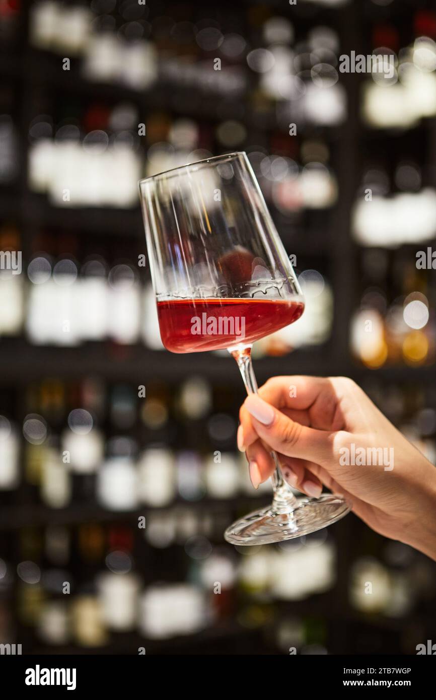 Woman's hand holding glass of red wine in restaurant interior Stock ...