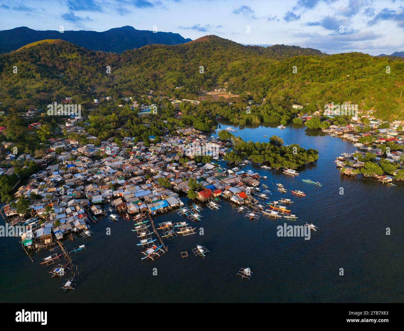 A tranquil scene of several boats docked in a calm body of water ...