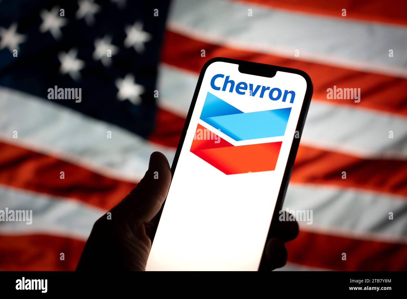 The Chevron logo is seen with an American flag in the background in ...