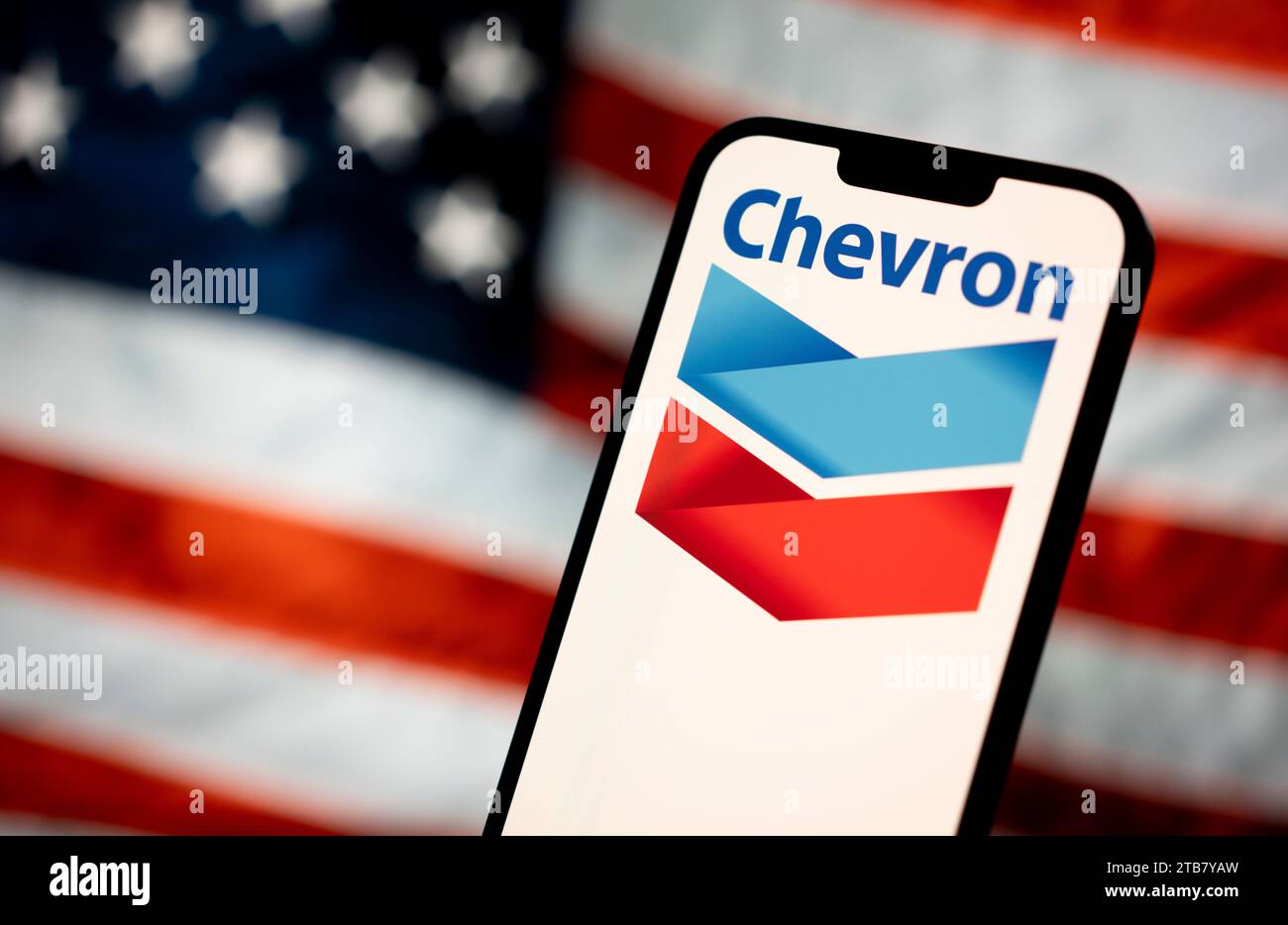 The Chevron logo is seen with an American flag in the background in ...