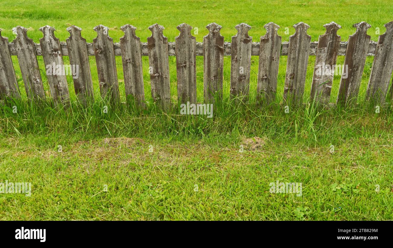 Old wooden picket fence in green grass as rural property boundary Stock ...