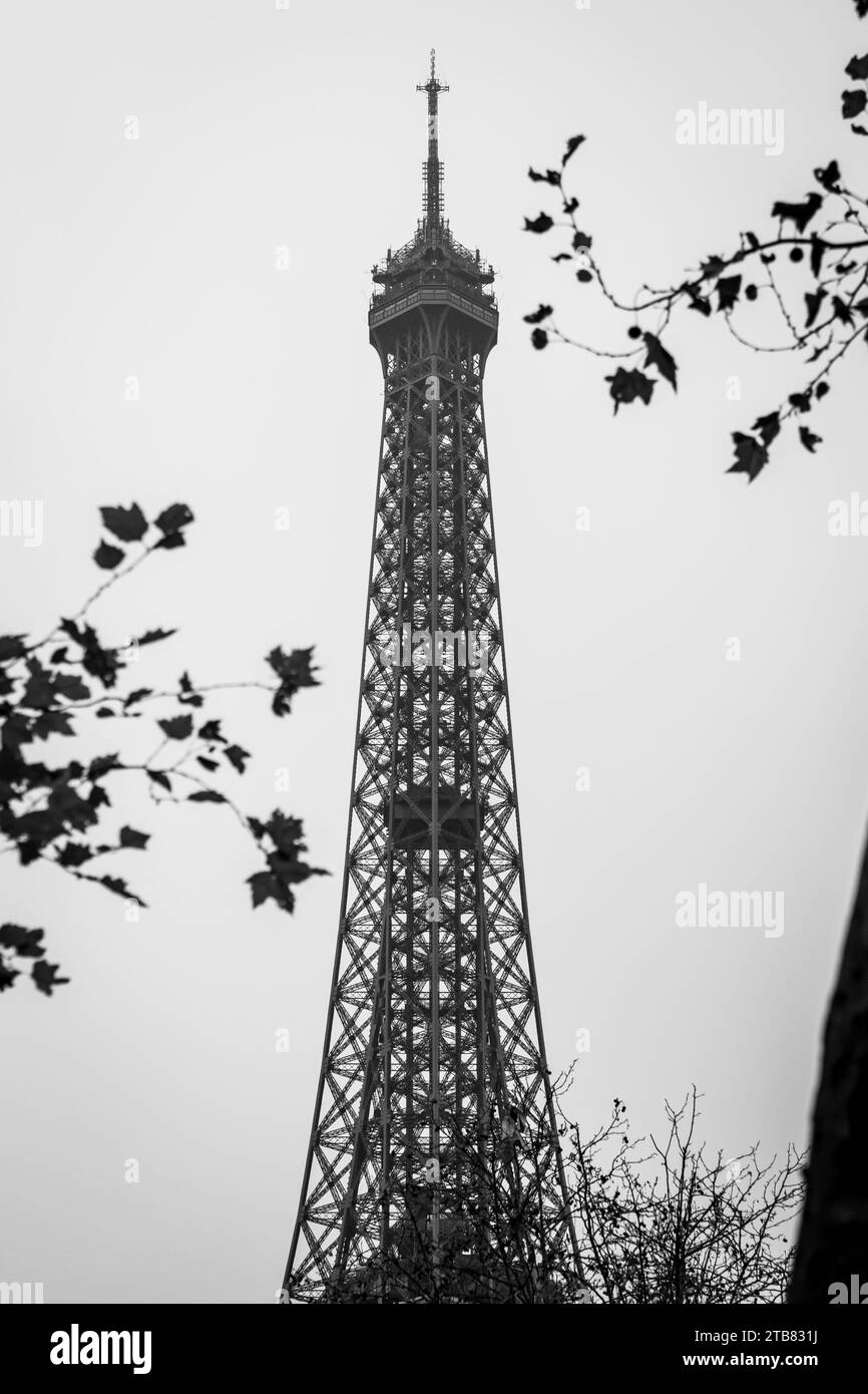 The spire of the Eiffel Tower in black and white in autumn in Paris - France Stock Photo