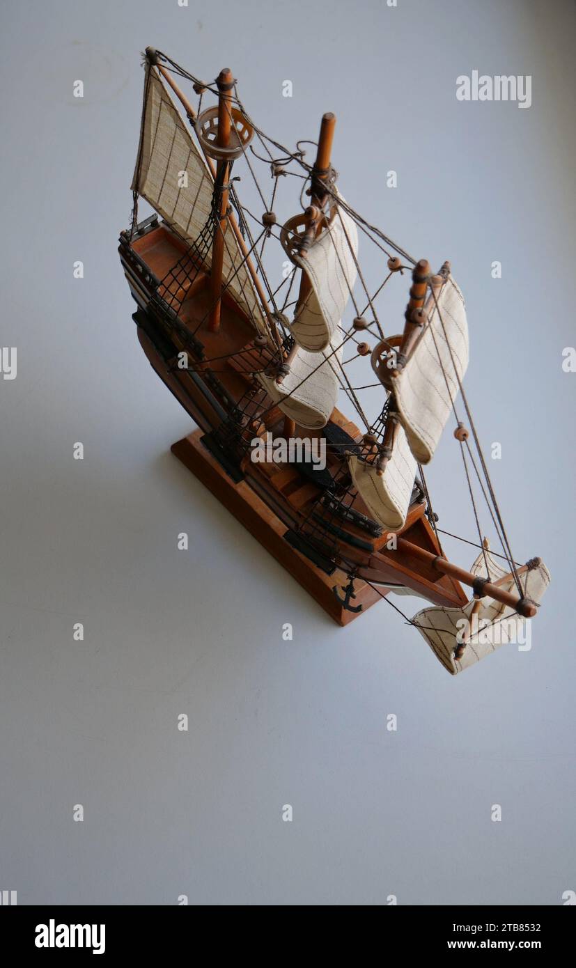 Model of sailing ship made of wood on a souvenir stand isolated on white vertical stock photo Stock Photo