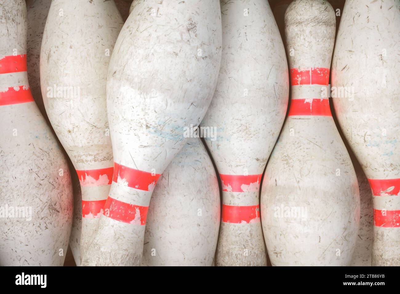 Vintage weathered white bowling pins with red stripe Stock Photo
