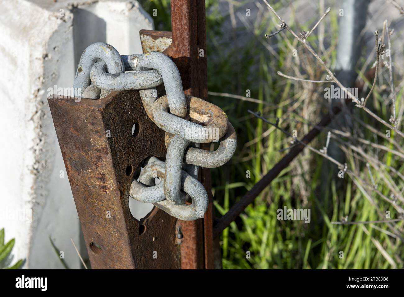 Stainless steel chains winding a rusty metal pole Stock Photo Alamy