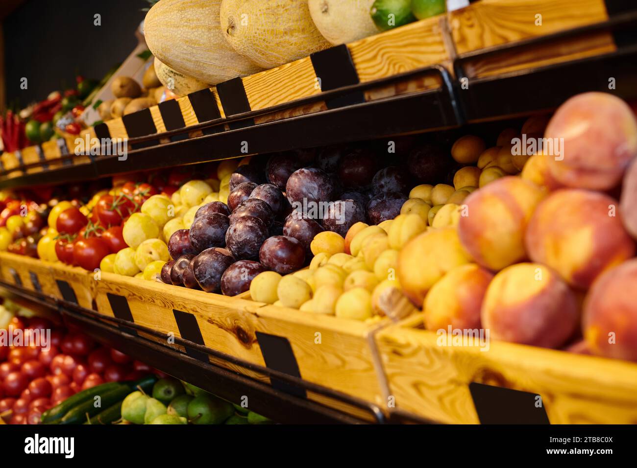 photo of colorful fruit stall with peaches, plums and melons at grocery