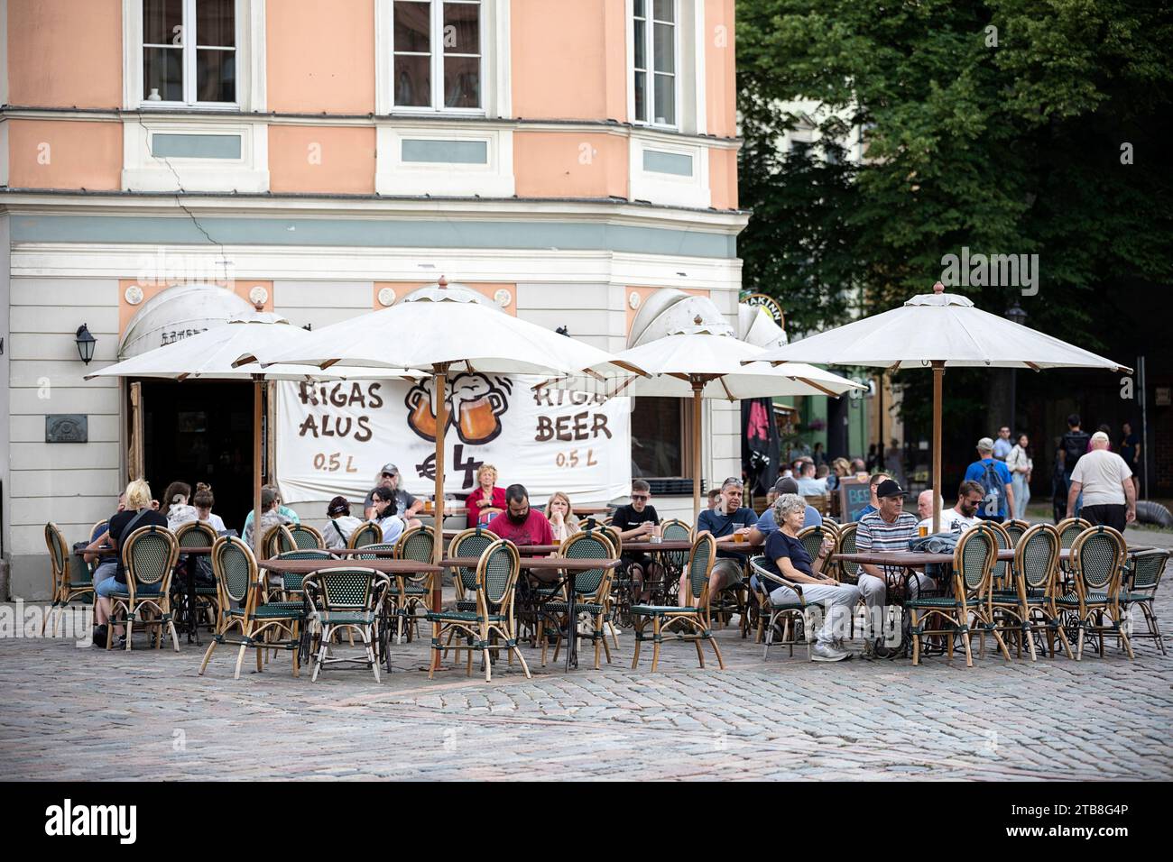Tourists and locals enjoying in local bar in old part of Riga city in Latvia Stock Photo