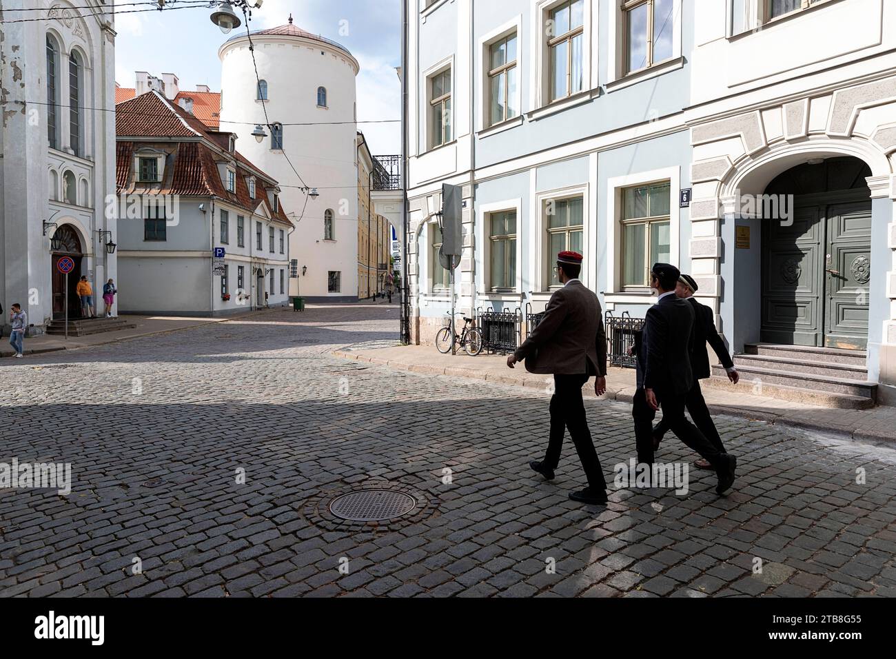 Tourists, locals, walking on a street in old part of Riga city in Latvia on a beautiful summer day Stock Photo