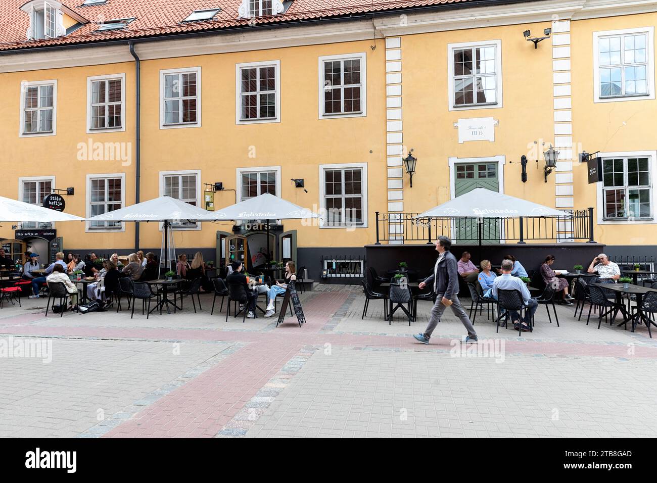 Tourists and locals enjoying in local bar in old part of Riga city in Latvi Stock Photo