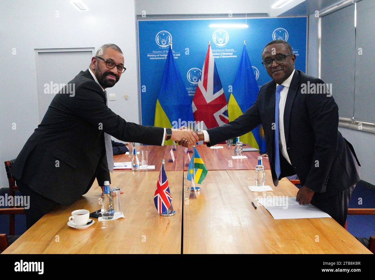 Home Secretary James Cleverly and Rwandan Minister of Foreign Affairs Vincent Biruta shake hands at bilateral meeting after they signed a new treaty in Kigali, Rwanda, Tuesday, Dec. 5, 2023. The treaty will address concerns by the Supreme Court, including assurances that Rwanda will not remove anybody transferred under the partnership to another country. (Ben Birchall/PA Wire via AP) Stock Photo