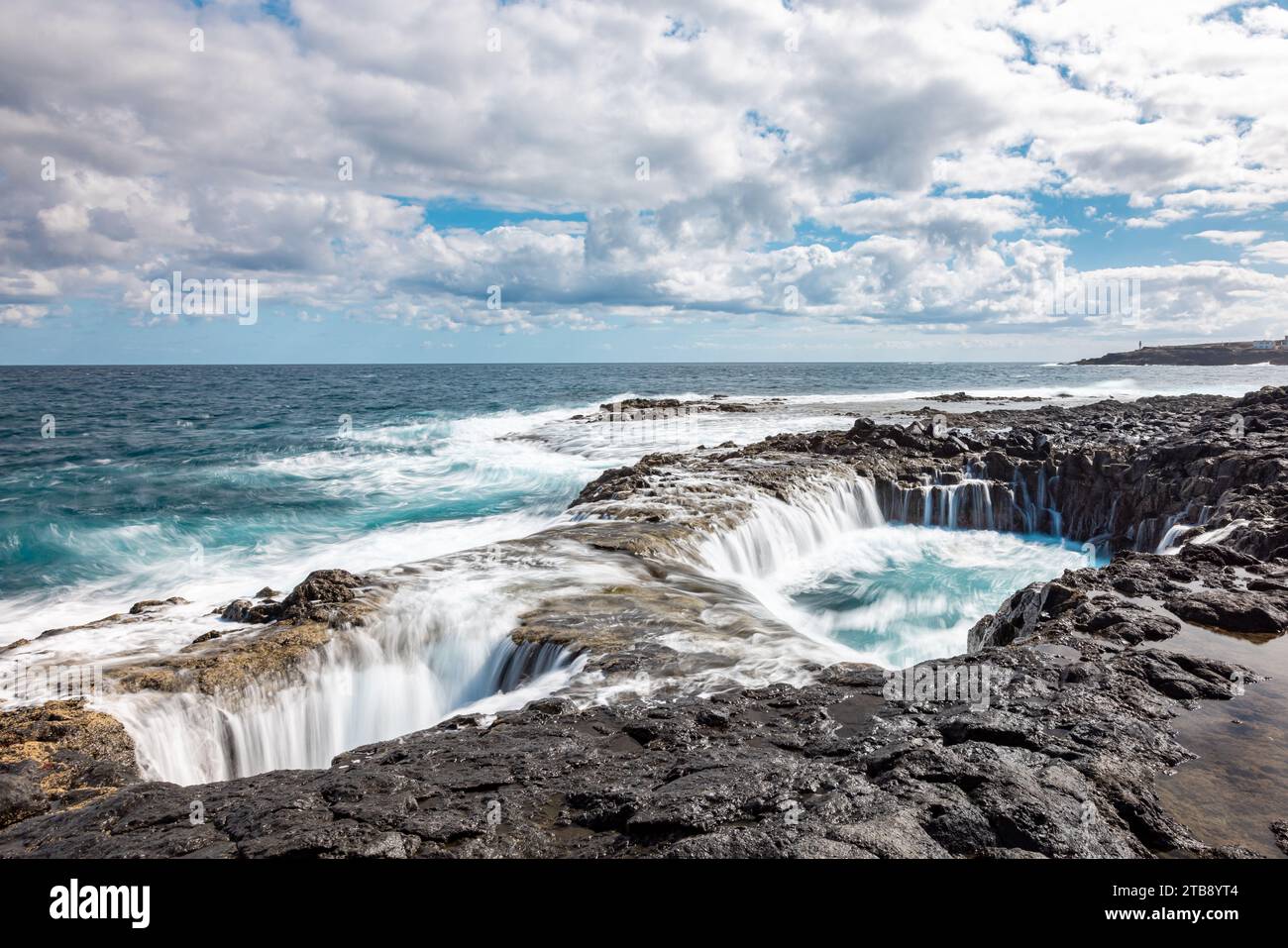 Spectacular natural phenomenon of Bufadero de la Garita where the water goes up and down in the hole like a waterfall with every wave, Gran Canaria is Stock Photo
