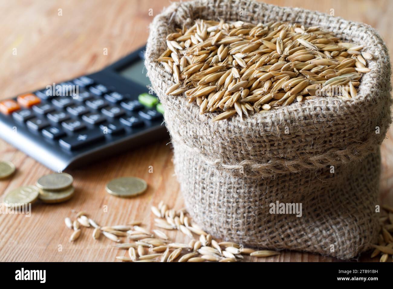 Sack of grain, calculator and coins, cereal prices and trade concept Stock Photo Alamy