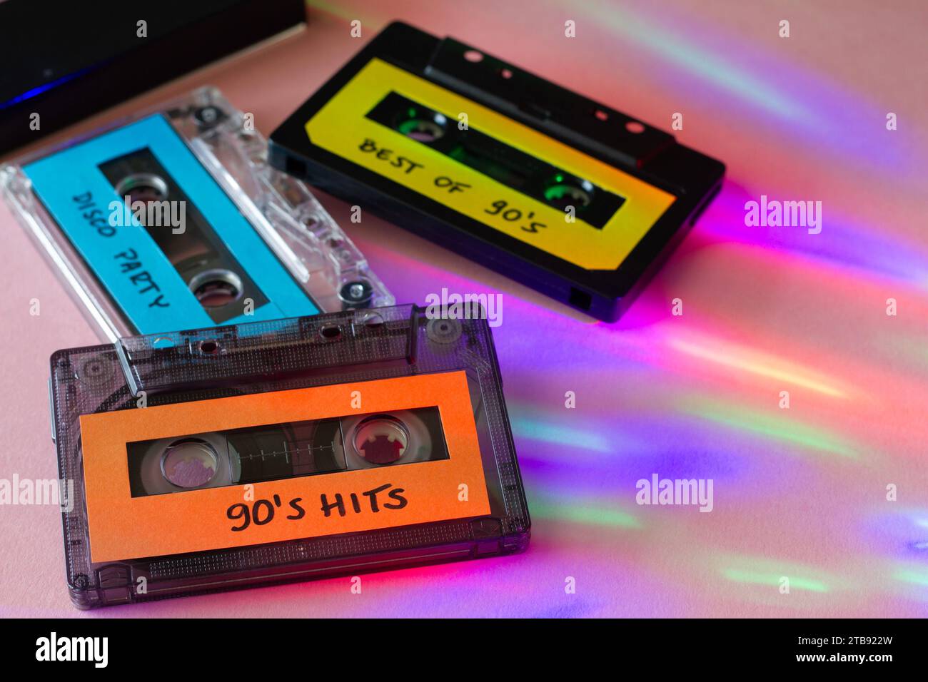 Retro cassettes with 90's music, disco party lights, 90's party concept Stock Photo