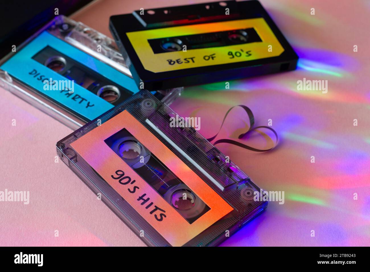 Retro cassette with 90's music with heart-shaped tape, disco party lights, the best music 90's, concept Stock Photo