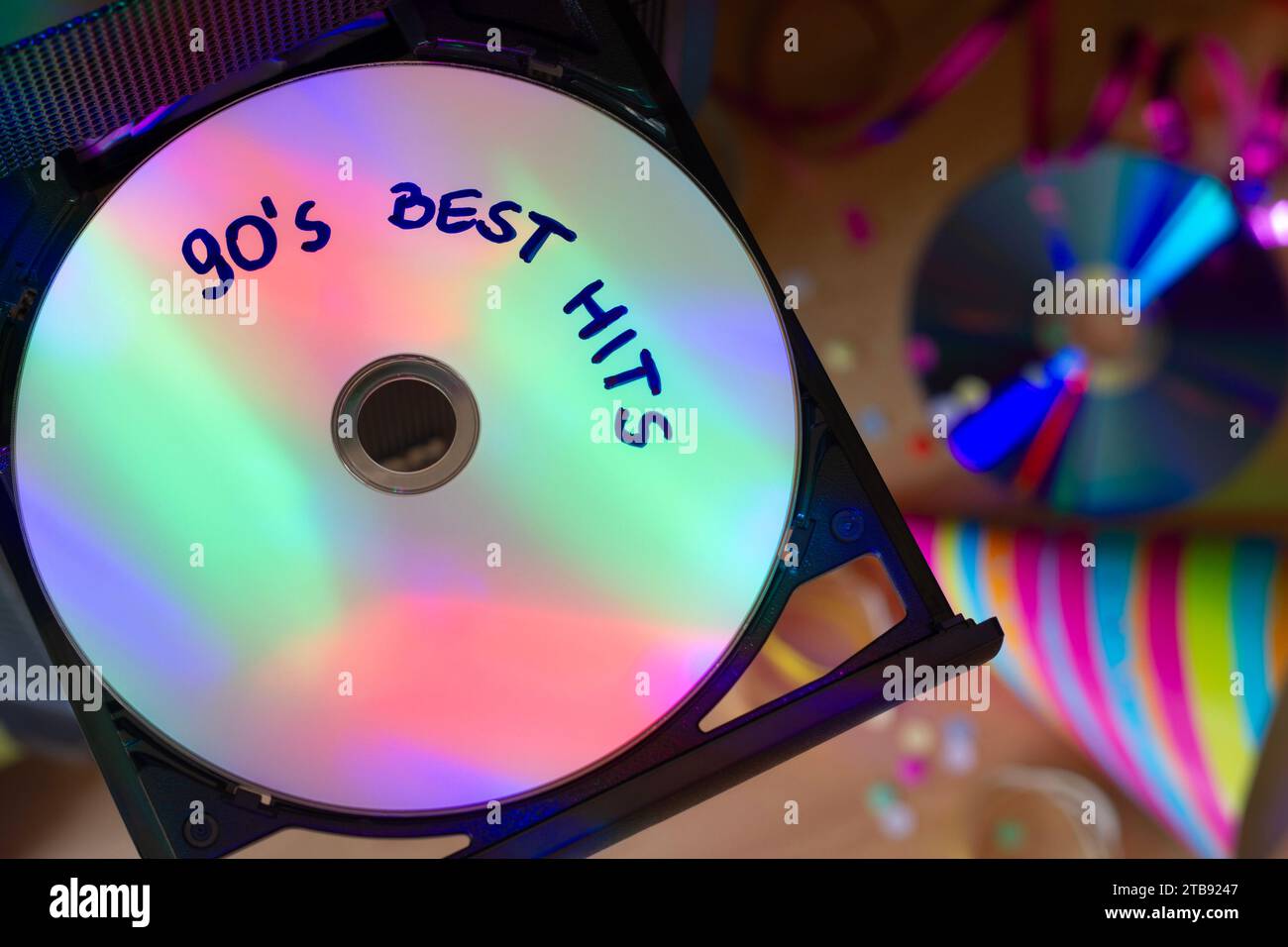 CD with music from 90s, disco party lights, party concept to 90s music Stock Photo