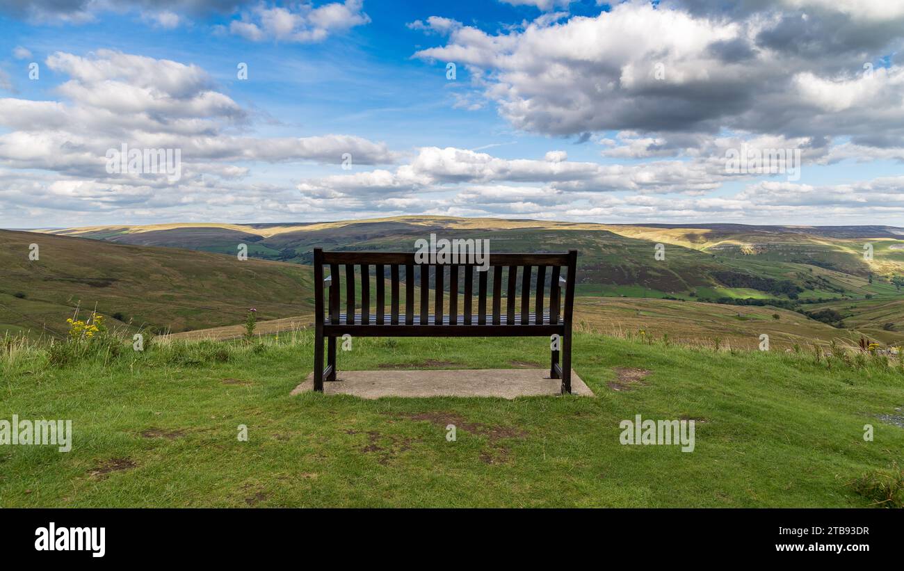 Bench with view over the Yorkshire Dales, near Thwaite, North Yorkshire, UK Stock Photo