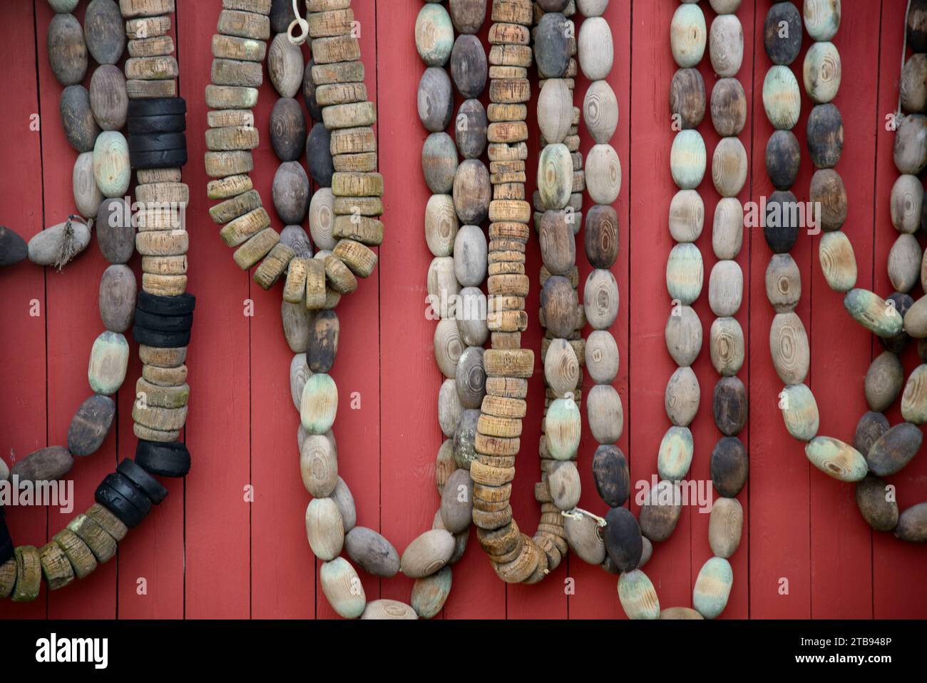 Fishing net floats and buoys hanging on a door; Petersburg, Alaska, United States of America Stock Photo
