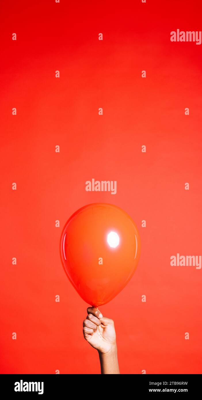 Holding Red Balloon Stock Photo - Download Image Now - Balloon, Stick -  Plant Part, Human Hand - iStock