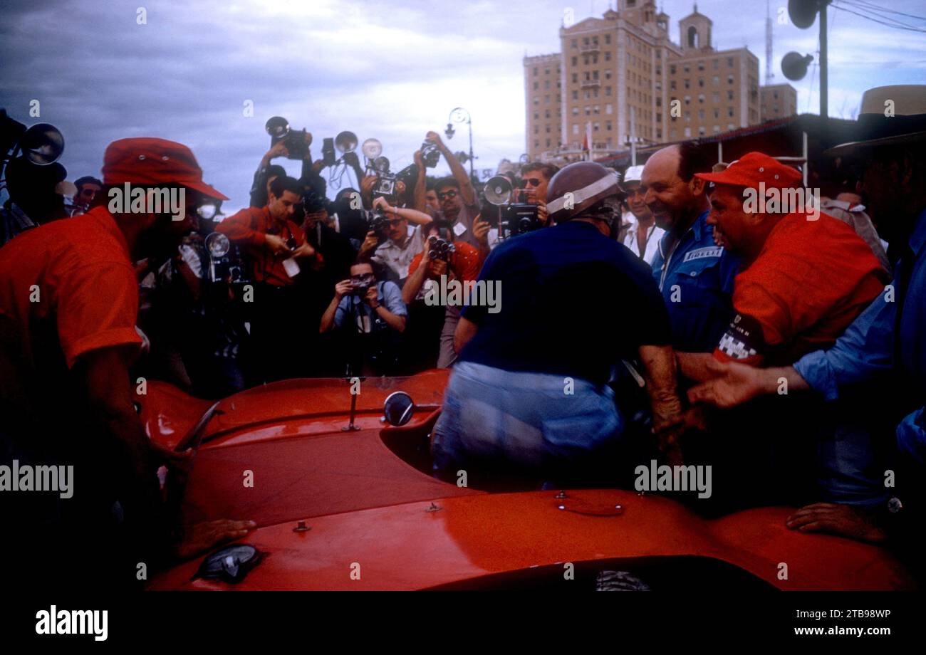 HAVANA, CUBA - FEBRUARY 24:  Juan Manuel Fangio (1911-1995) driver of the Maserati 300S climbs out of his car after winning the 1957 Cuban Grand Prix on February 24, 1957 in Havana, Cuba.  (Photo by Hy Peskin) *** Local Caption *** Juan Manuel Fangio Stock Photo