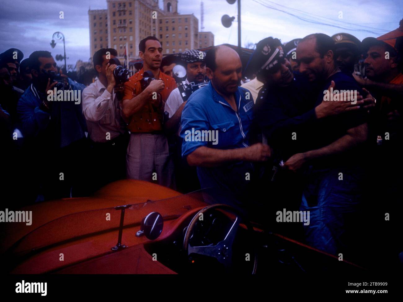HAVANA, CUBA - FEBRUARY 24:  Juan Manuel Fangio (1911-1995) driver of the Maserati 300S climbs out of his car after winning the 1957 Cuban Grand Prix on February 24, 1957 in Havana, Cuba.  (Photo by Hy Peskin) *** Local Caption *** Juan Manuel Fangio Stock Photo