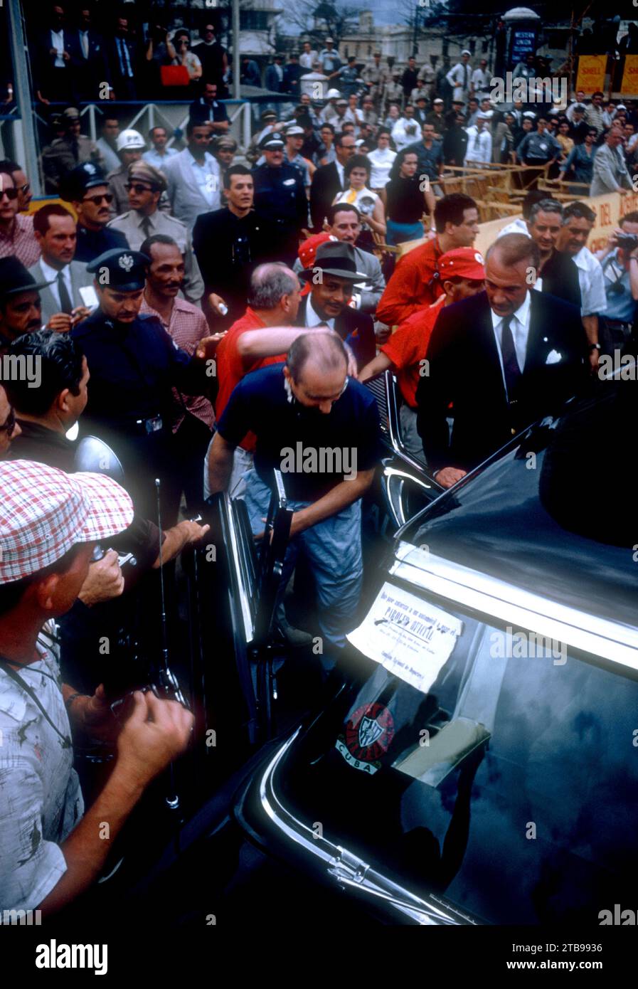 HAVANA, CUBA - FEBRUARY 24:  Juan Manuel Fangio (1911-1995) driver of the Maserati 300S and actor Gary Cooper (1901-1961) get into a car after the 1957 Cuban Grand Prix on February 24, 1957 in Havana, Cuba.  Fangio won the race.  (Photo by Hy Peskin) *** Local Caption *** Juan Manuel Fangio;Gary Cooper Stock Photo