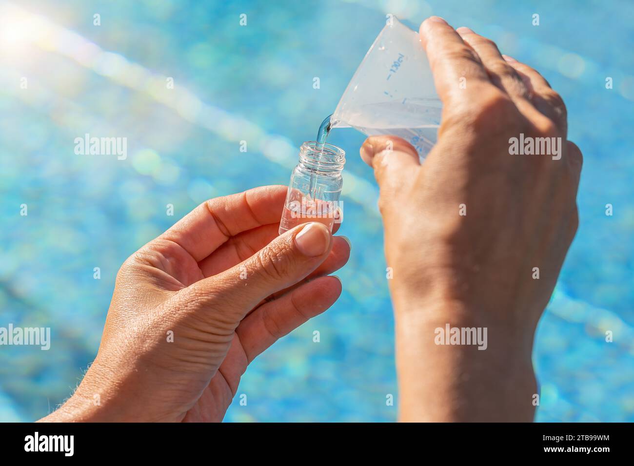 service engineer hands pouring water into testing vial for PH value