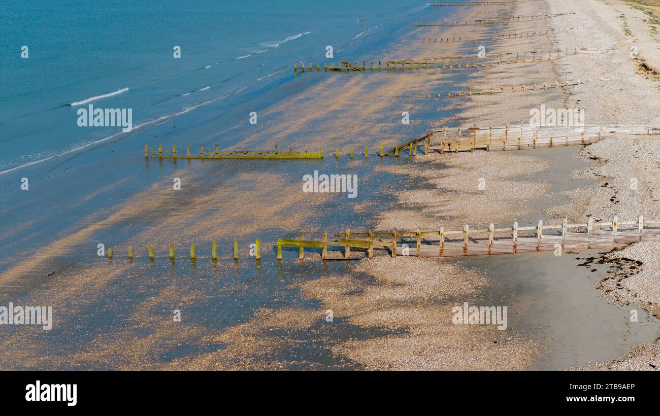 Bracklesham Bay on a sunny summer morning. Elevated view showing the great beach and seaside landscape. Groynes protecting the beach from erosion. Stock Photo