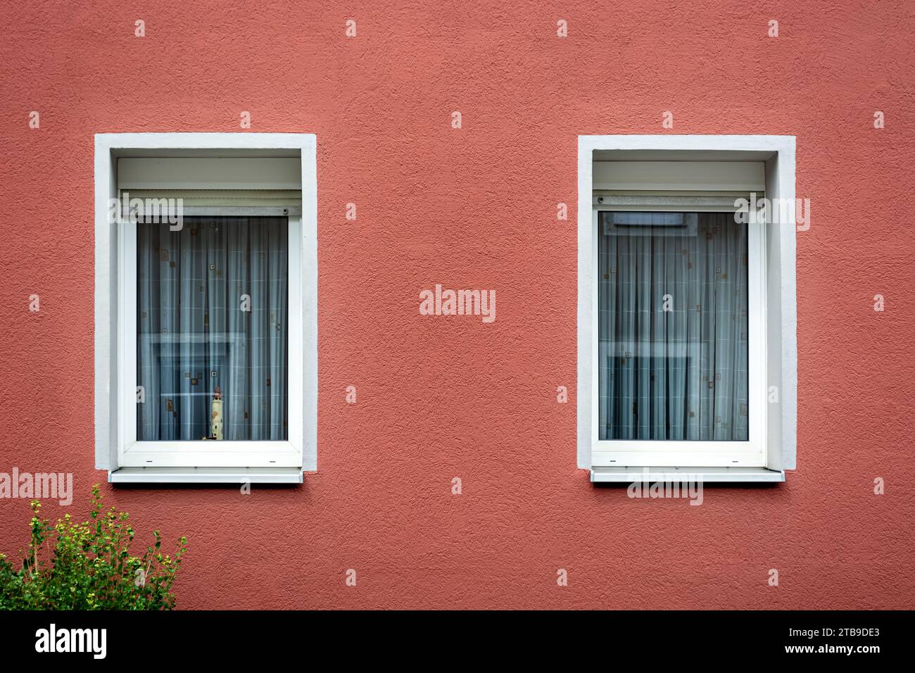 Two rectangular windows with a white frame against a pink plastered wall. From the Windows of the world series. Stock Photo