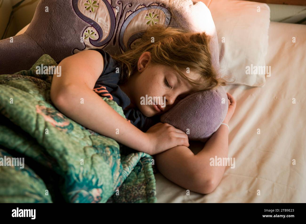Girl asleep in her bed; Stone Harbor, New Jersey, United States of America Stock Photo