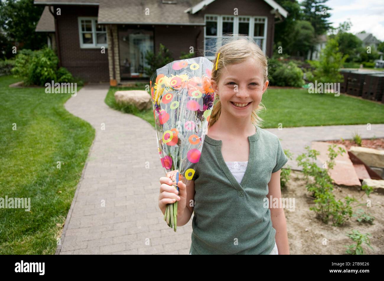 Girl brings home a bouquet of flowers; Lincoln, Nebraska, United States of America Stock Photo