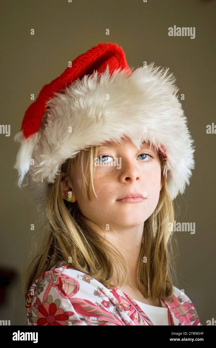 Portrait of a 10-year-old girl in her Santa hat; Lincoln, Nebraska, United States of America Stock Photo