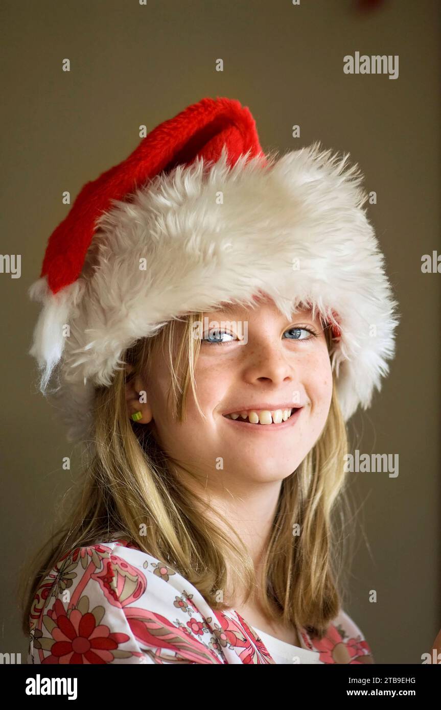 Portrait of a 10-year-old girl in her Santa hat; Lincoln, Nebraska, United States of America Stock Photo