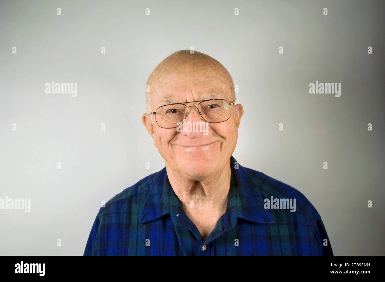 Portrait of an elderly man with a plaid shirt against a white background; Lincoln, Nebraska, United States of America Stock Photo