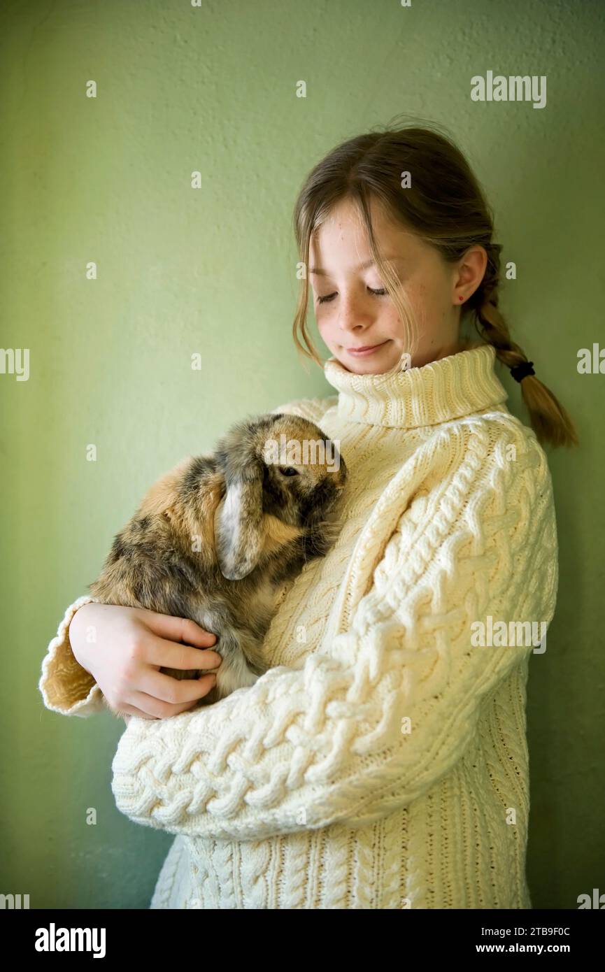 Portrait of a young girl with her pet rabbit; Lincoln, Nebraska, United States of America Stock Photo