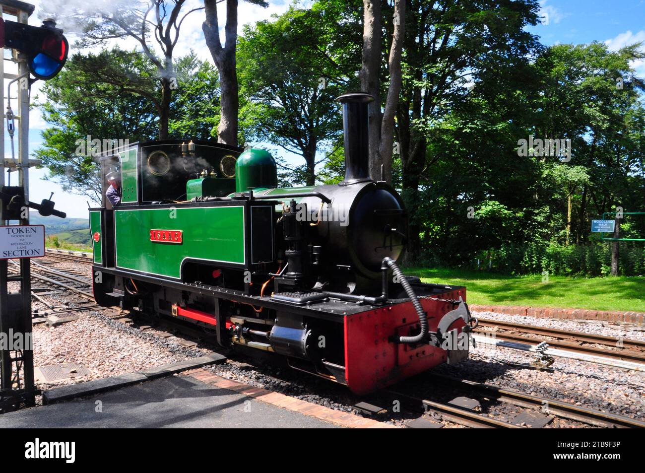 Steam locomotive 'Isaac' at Woody Bay station on the narrow gauge Lynton and Barnstaple Railway, Devon, England Stock Photo