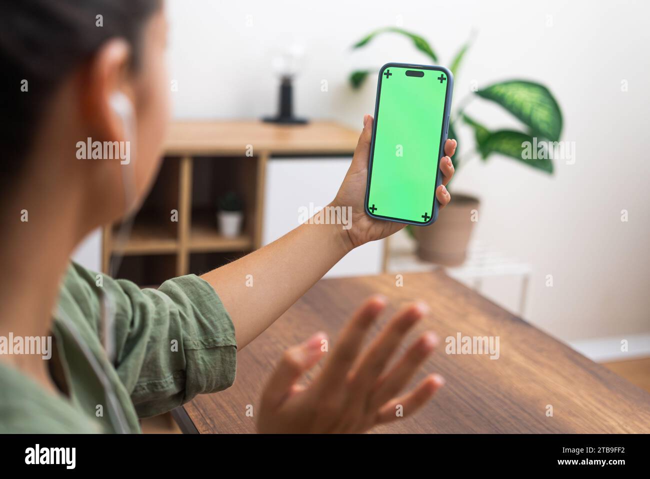 woman connects with doctor online call on smartphone, chroma key screen  Stock Photo