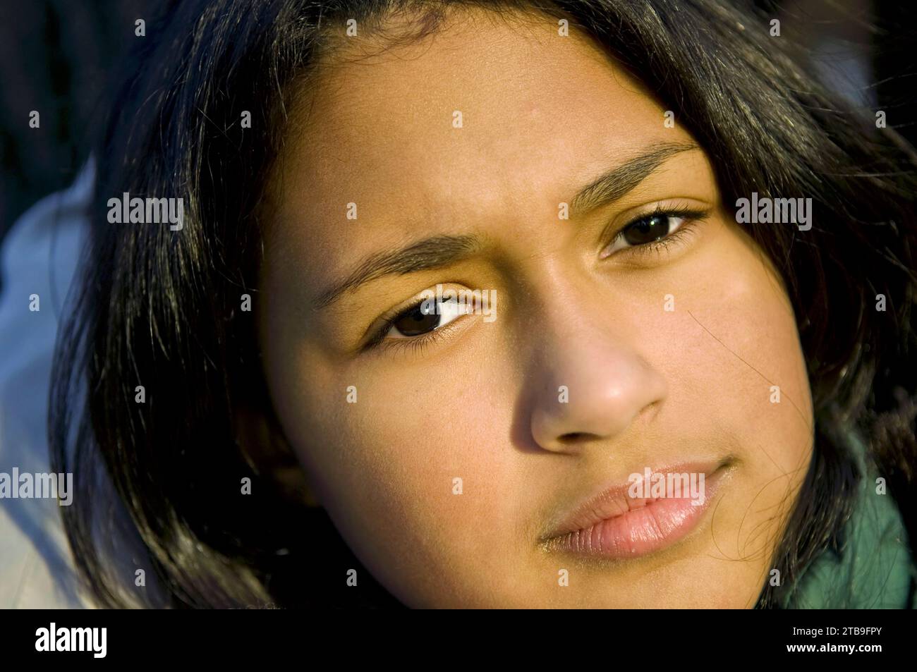 Close-up of a girl's face illuminated in warm sunlight; Staten Island, New York, United States of America Stock Photo