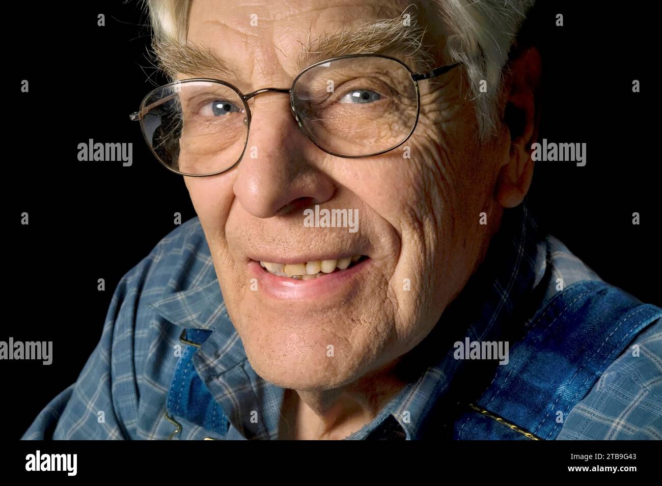 Portrait of an elderly man against a black background; Studio Stock Photo