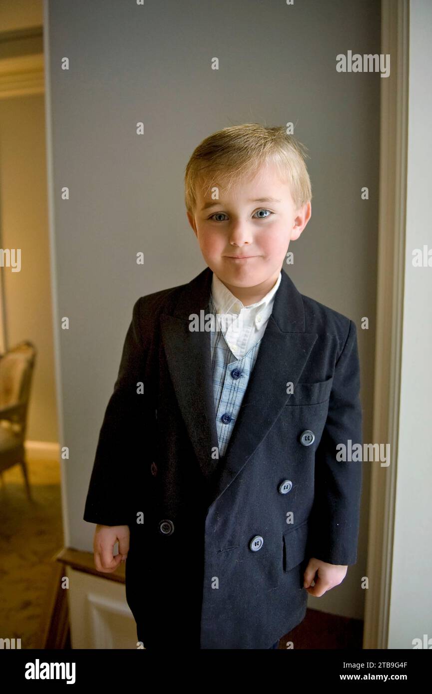 Young boy in dress clothes poses for a photograph; Lincoln, Nebraska, United States of America Stock Photo