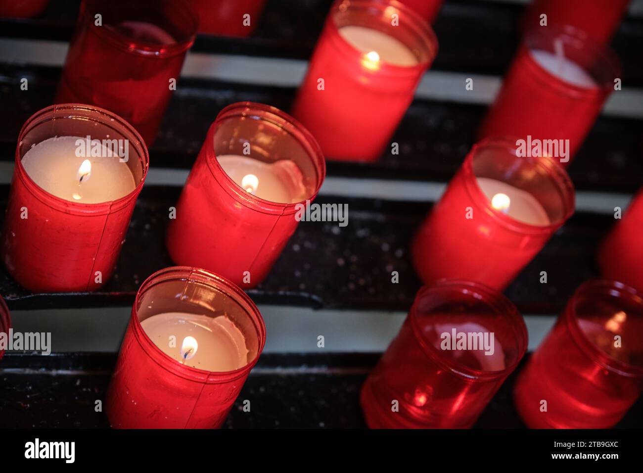 red prayer candles in front of the altar in Convento de San Esteban Salamanca, Spain Stock Photo