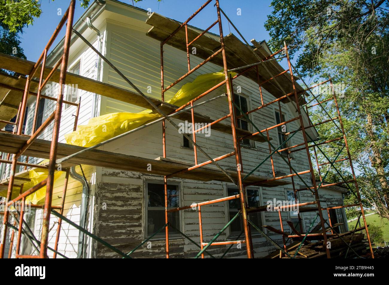 Old house is remodeled, with scaffolding being used to replace the