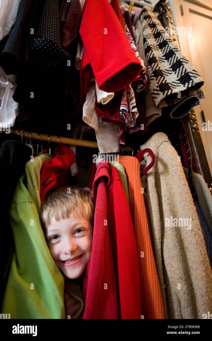 Young boy plays in his mother's closet; Lincoln, Nebraska, United States of America Stock Photo
