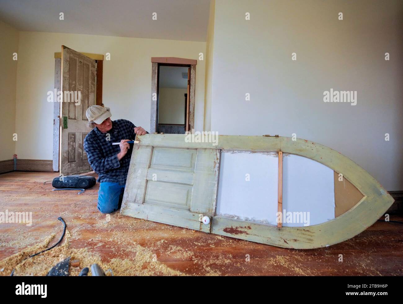 Carpenter works to renovate an old farmhouse; Dunbar, Nebraska, United States of America Stock Photo