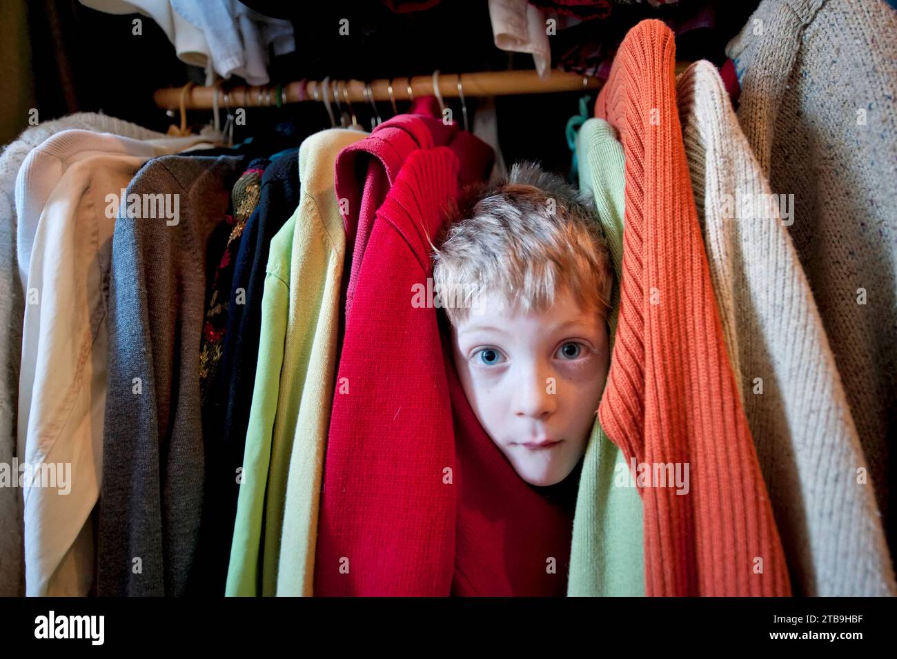 Young boy plays in his mother's closet; Lincoln, Nebraska, United States of America Stock Photo