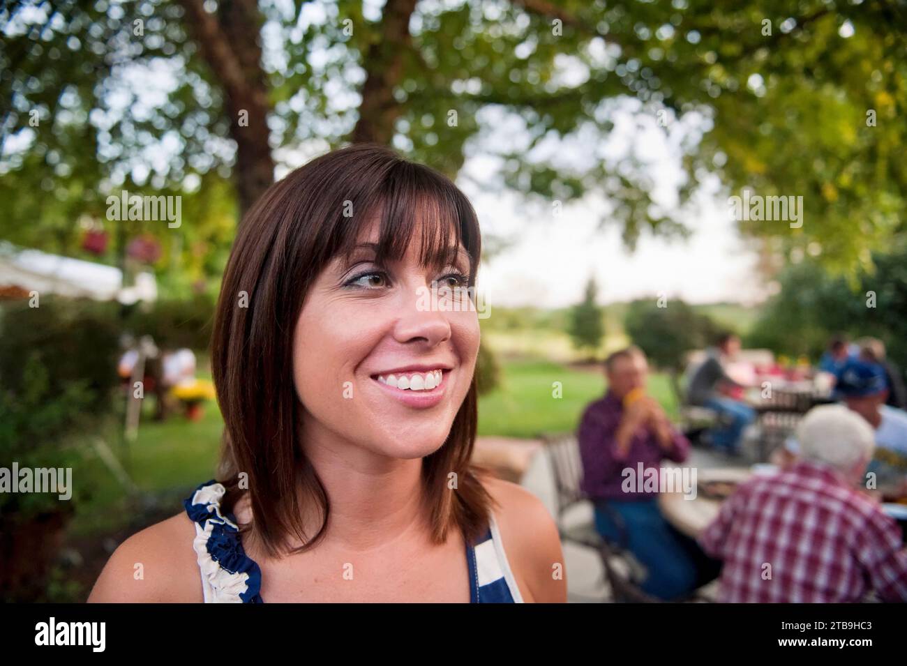 Woman enjoys an outdoor party; Lincoln, Nebraska, United States of America Stock Photo
