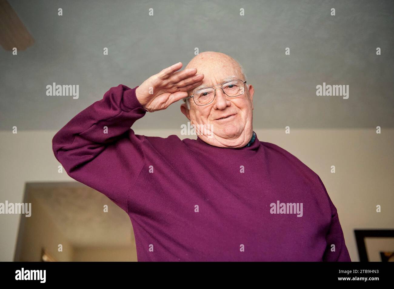 Elderly man salutes the camera; Elkhorn, Nebraska, United States of America Stock Photo